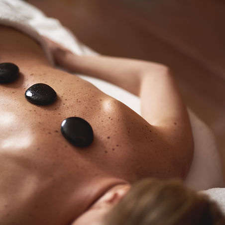 Therapeutic volcanic hot stones in action during massage